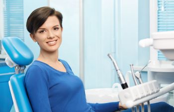 A woman sitting in a dentist's chair.