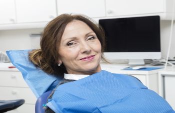 A woman sitting in a dentist's chair.