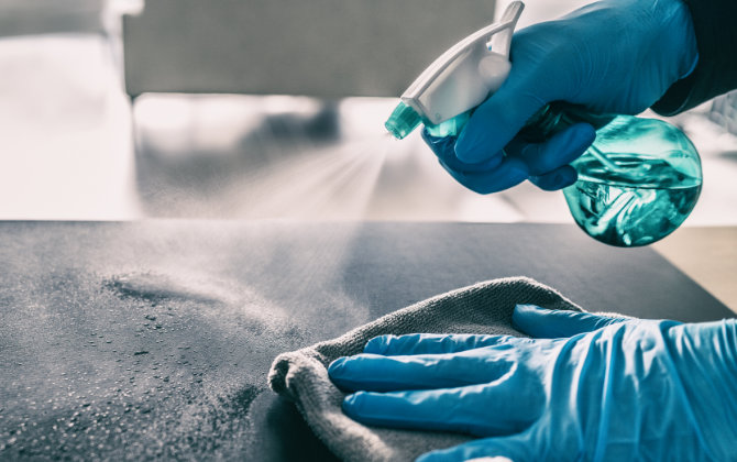 A person sterilizing surfaces between appointments at Elegant Smiles Dentistry Atlanta, GA.