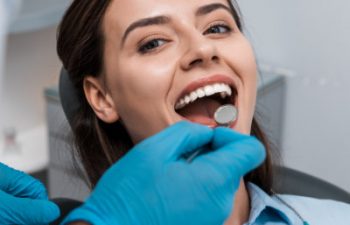 A woman is getting her teeth examined by a dentist.