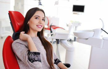 A woman sitting in a dentist's chair.