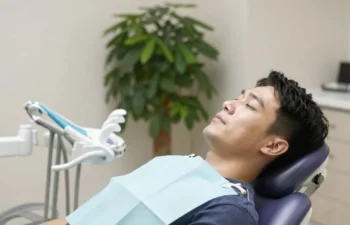 Relaxed patient in dental chair during sedation dentistry treatment visit